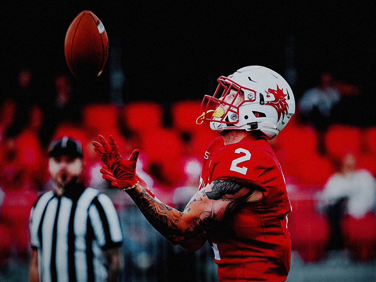 Receiver catching the ball wearing red REYRR ZERO gloves on game day